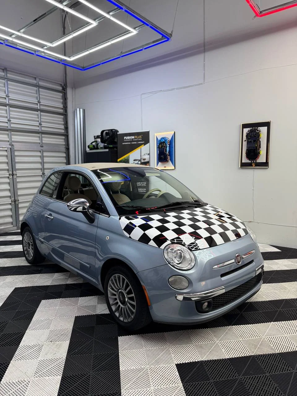 Checkerboard hood wrap photographed inside the workshop